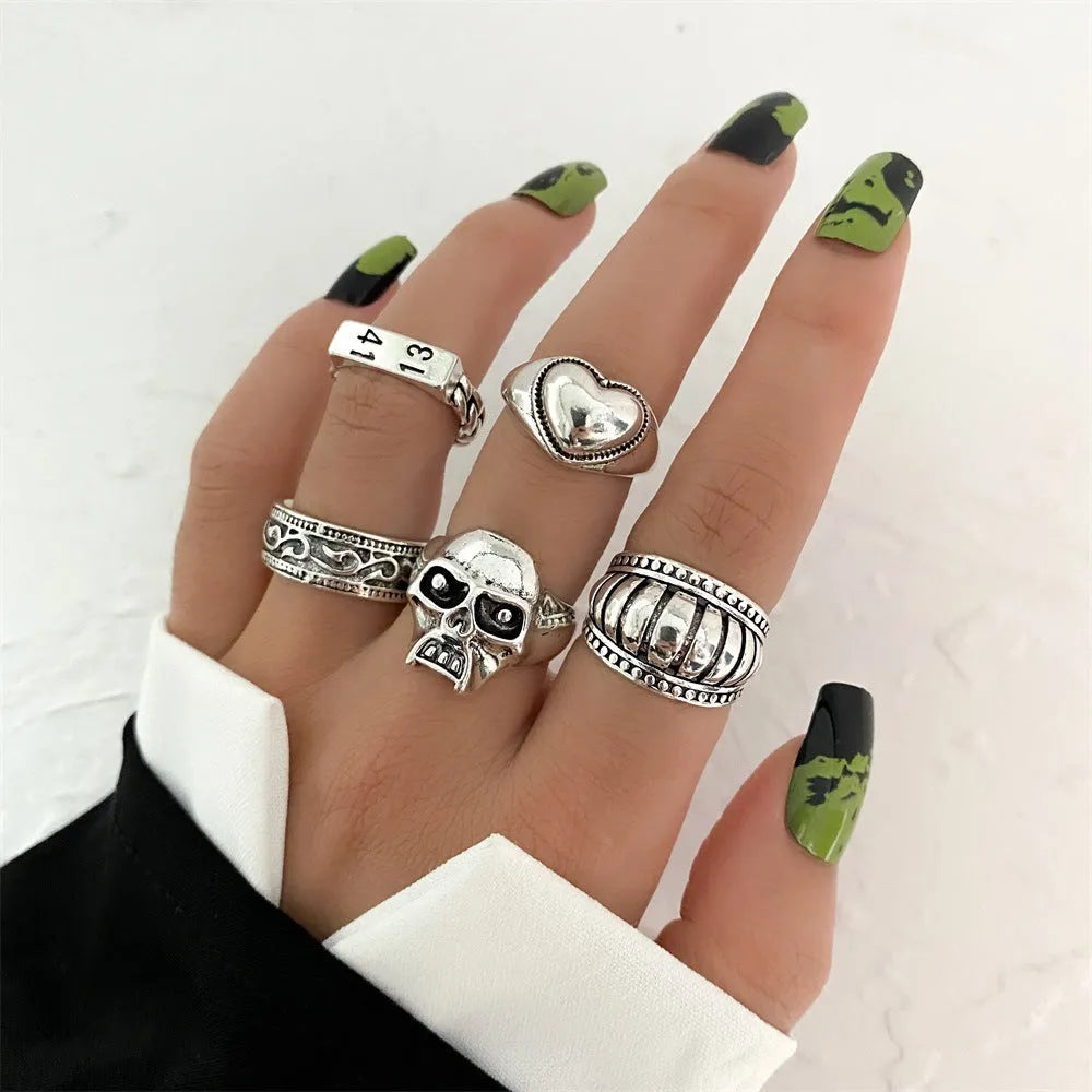 Alloy ring set with butterfly and snake retro geometric designs on display