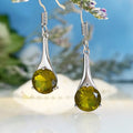 Olive green topaz coloured drop earrings with a water drop shape and retro style on a white background.