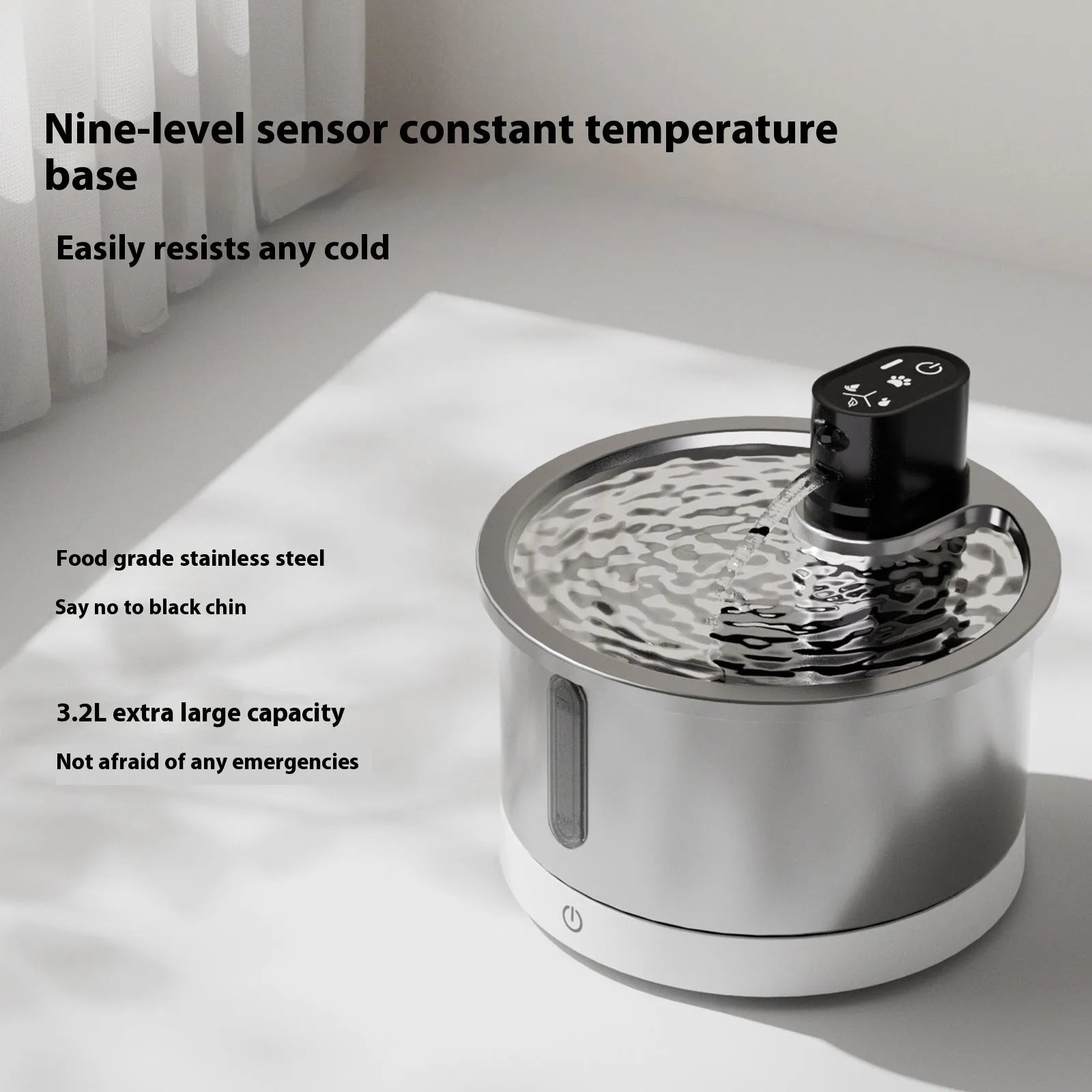 Stainless steel pet water fountain with white heating base on a kitchen floor