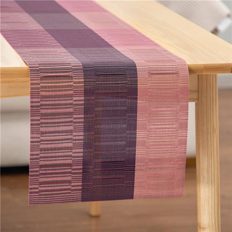 Modern non-slip PVC dish mat with gradient bamboo pattern in black, placed on a wooden dining table.