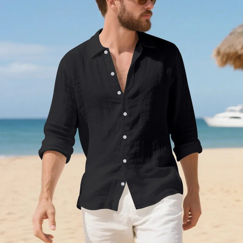 A man wearing a loose-fit light blue linen casual shirt with a non-iron finish, buttoned front and standard collar.
