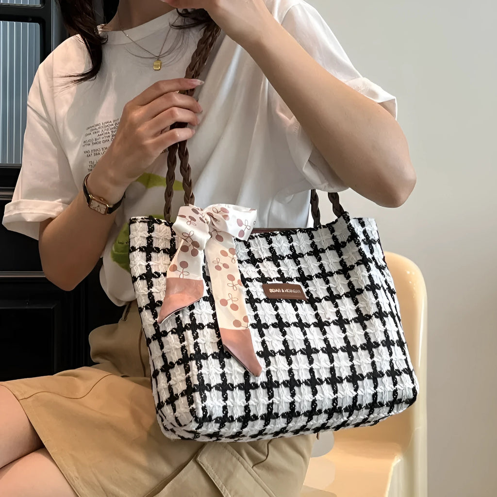 Black woolen horizontal square shoulder bag with weaving detail exterior and internal organisation compartments