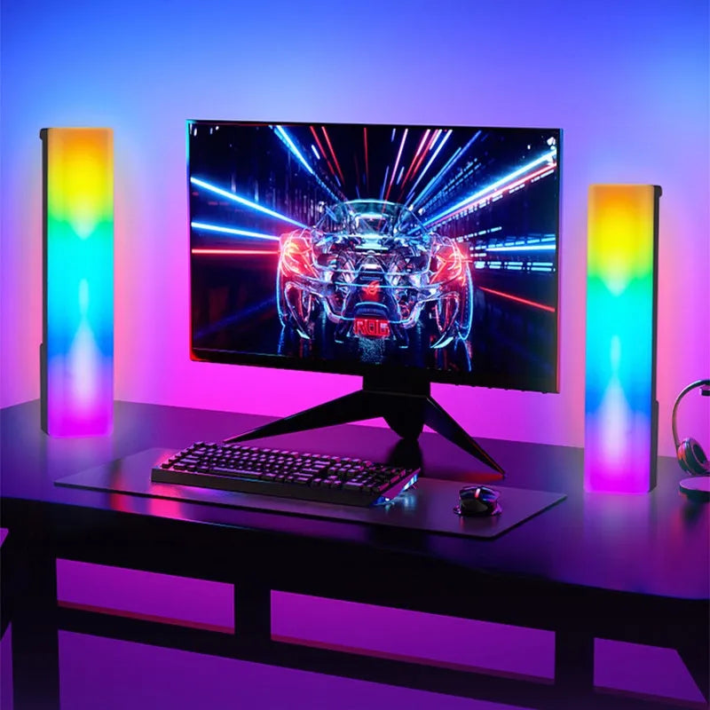 A tall, colourful RGB table lamp with a white or black shell reacting to sound on a desk.