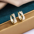 Geometric drop earrings with zircon stones and 14K yellow gold plating on copper