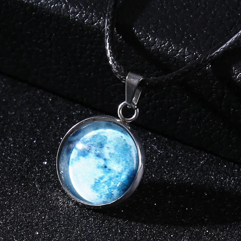 Luminous moon and star constellation pendant necklace with a silver-tone chain on a black background.