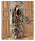 Long faux fur coat with a textured fox fur collar and side pockets.
