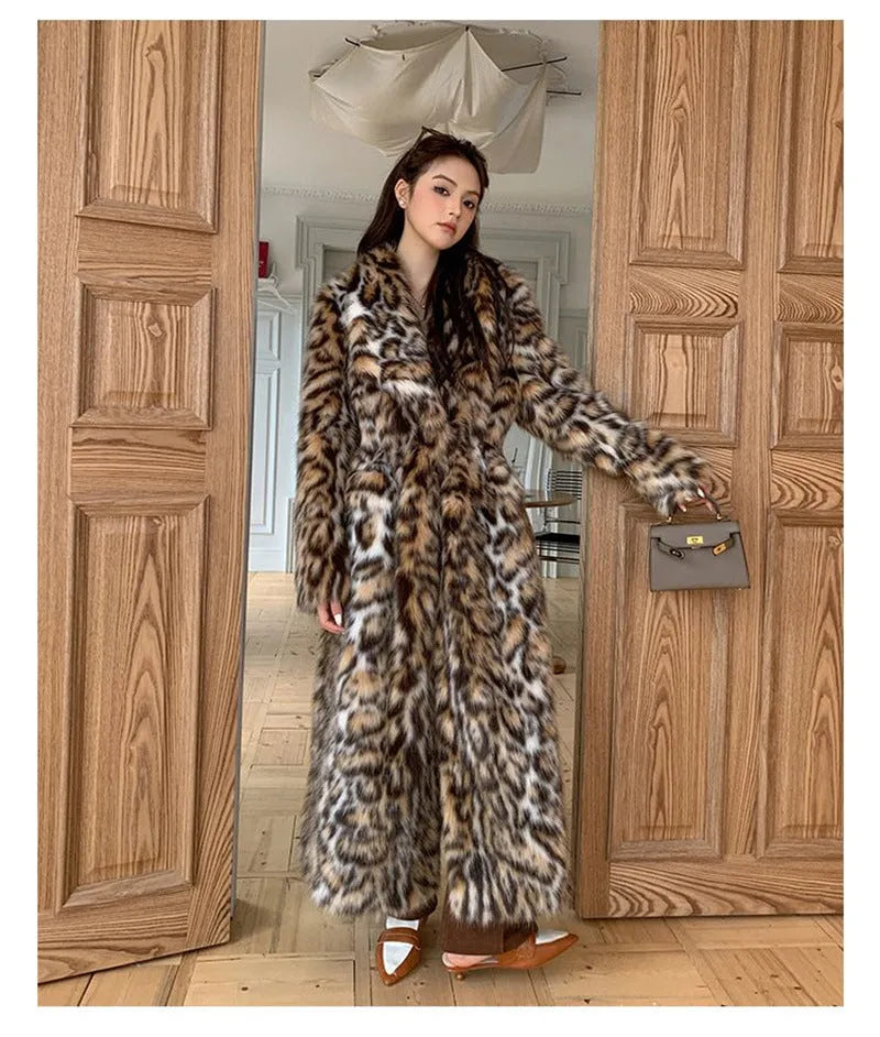 Long faux fur coat with a textured fox fur collar and side pockets.