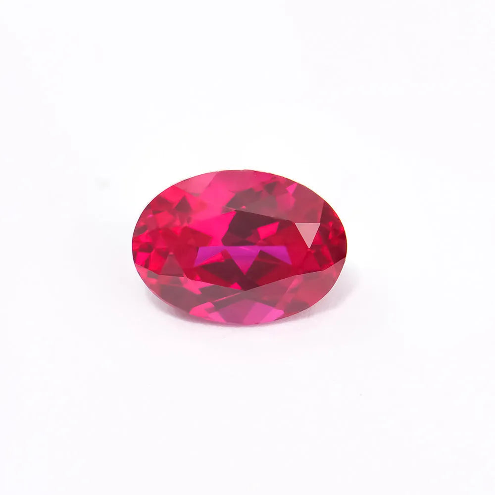 A loose, faceted artificial ruby gemstone in a deep pigeon blood red colour.