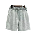 Men's charcoal black cotton shorts with a distressed finish and straight loose leg.