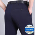 Men's dark blue straight-leg suit trousers with a high waist and non-iron finish on a hanger.