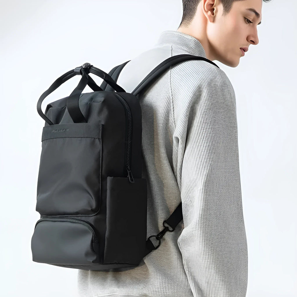 Black Oxford cloth computer backpack showing organisational storage compartments and laptop section
