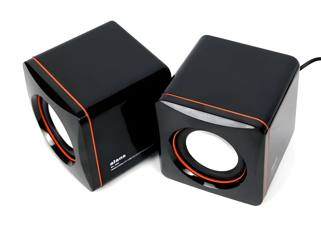 Small black square USB-powered 2.0 computer speaker on a desk.