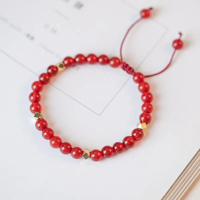 Hand-woven natural red agate bracelet showing diamond-shaped beads in ethnic woven pattern