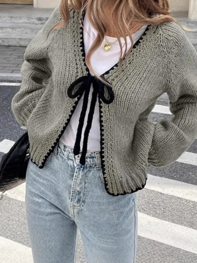 Lace-up cardigan sweater with crocheted flower detailing in solid colour