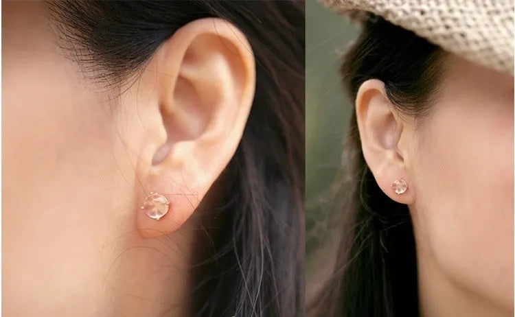 Rose gold drop shape stud earrings with crystal inlay detail on a silver base.