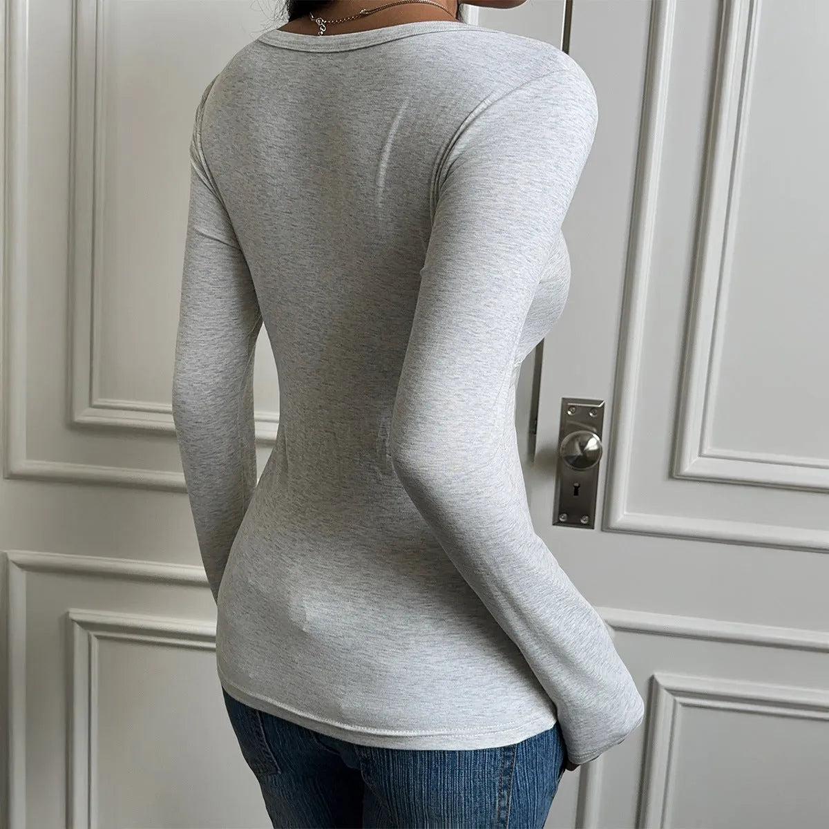 Women's gray slim fit long sleeve base layer t-shirt on model, front view