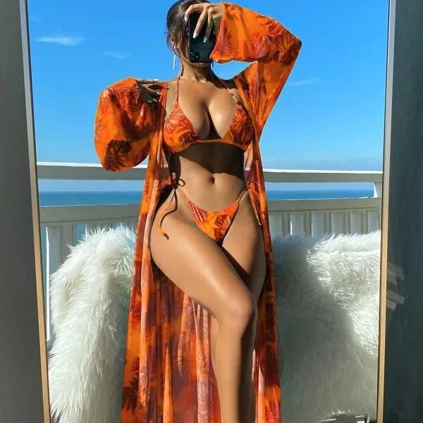 Women's blue banded bikini set with a long-sleeve floral cover-up blouse