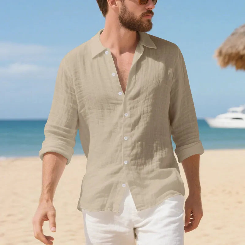 A man wearing a loose-fit light blue linen casual shirt with a non-iron finish, buttoned front and standard collar.