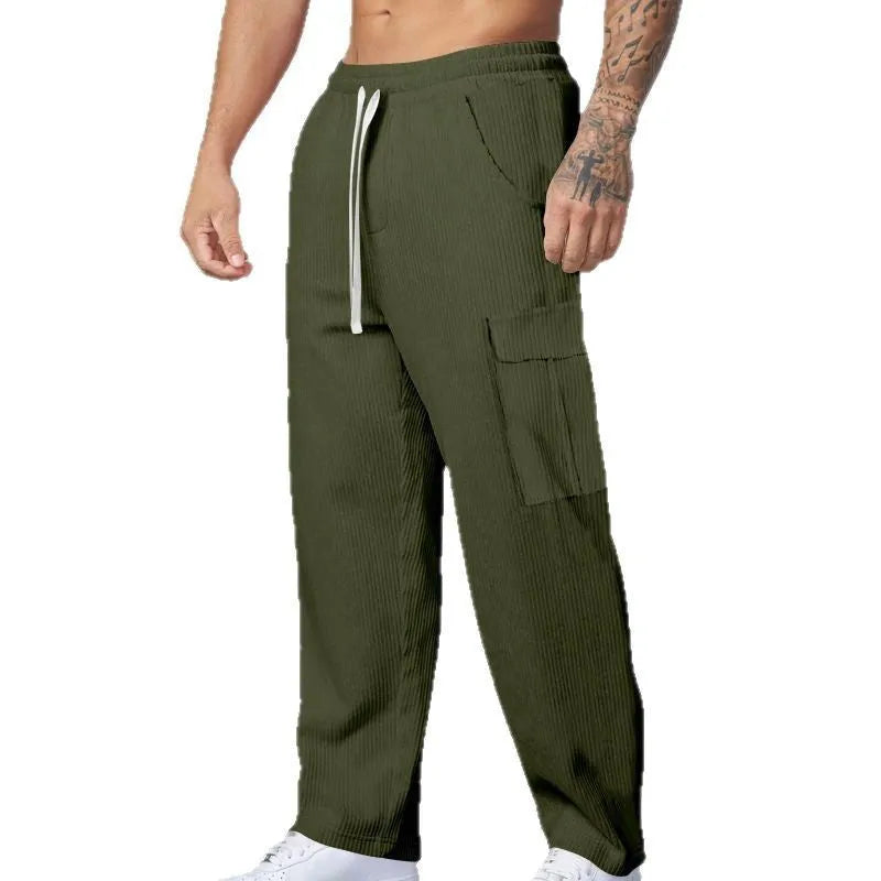 Men's straight-leg corduroy trousers in navy blue, showing loose fit and drawstring waist detail.