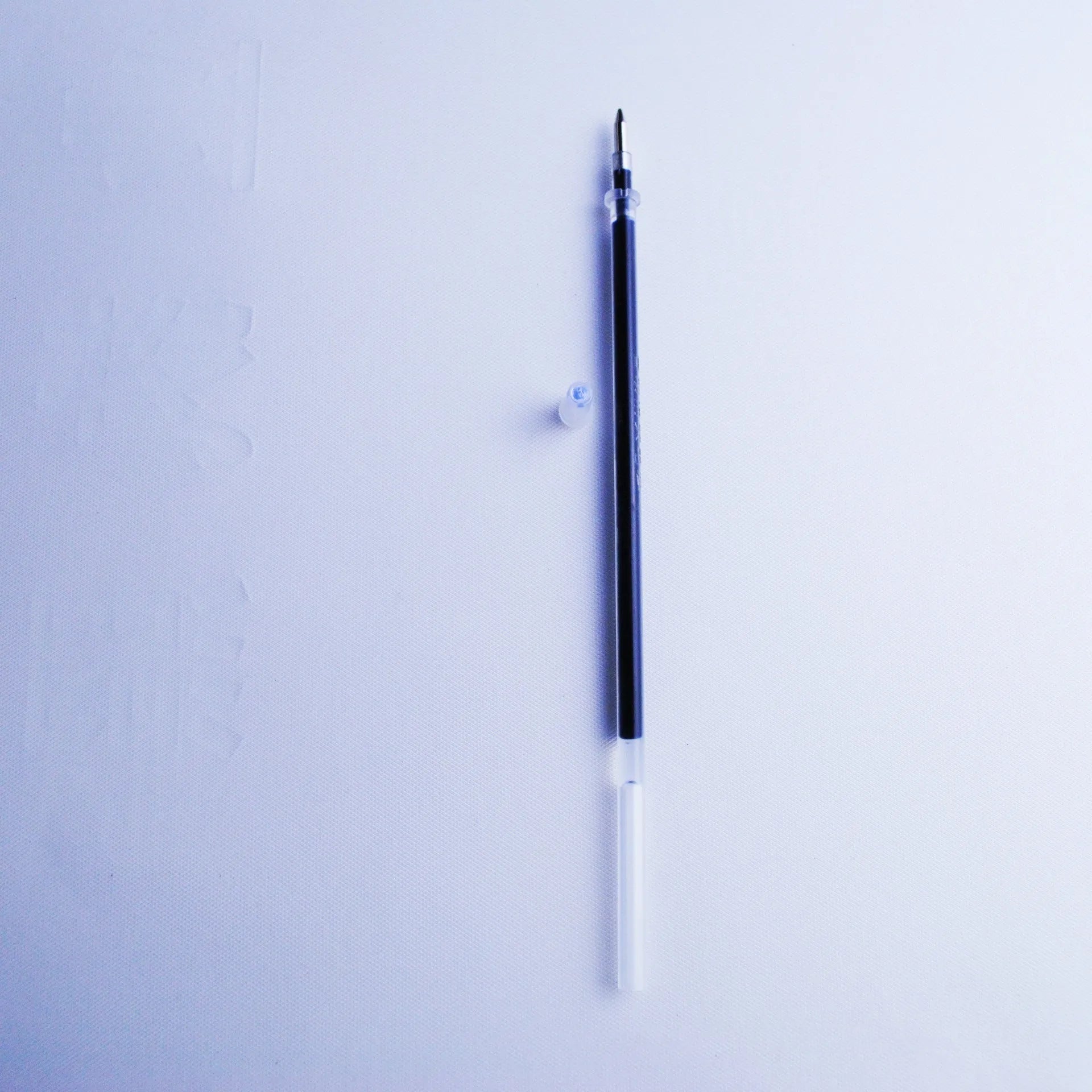 Portable fading ink pen set with 0.5mm tip, blue refills, and plastic body.
