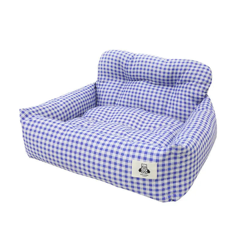 Grey and blue plaid cloth dog nest mounted in a car for pet travel.