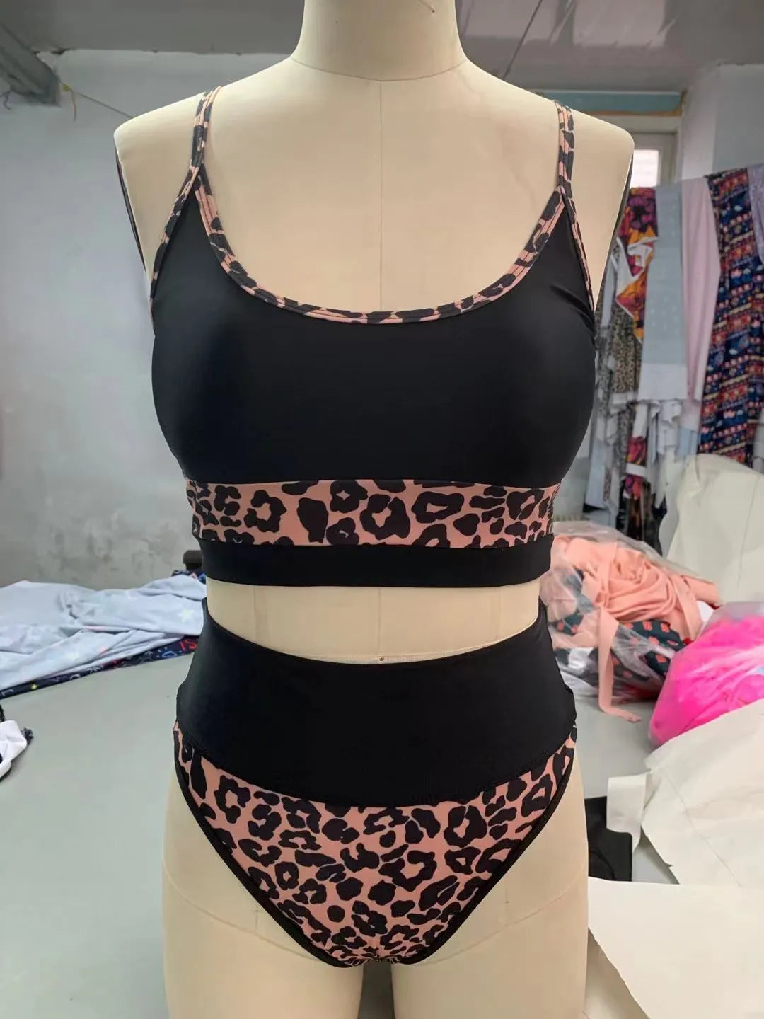 Women's high-waist split bikini swimsuit in leopard print and white colour options.