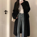 A loose, thick chenille cardigan sweater with a 3D textured pattern in a dark grey colour.