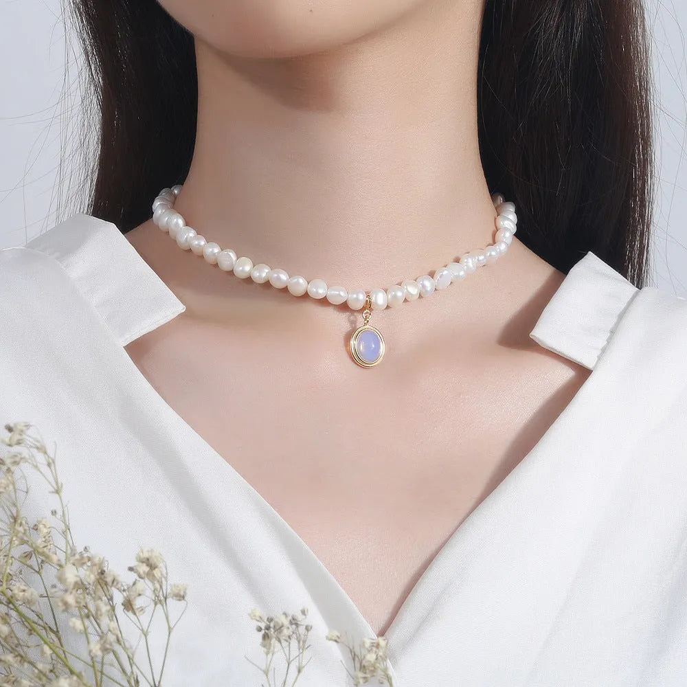 Silver necklace with round medal and irregular pearl geometric pendant on adjustable chain