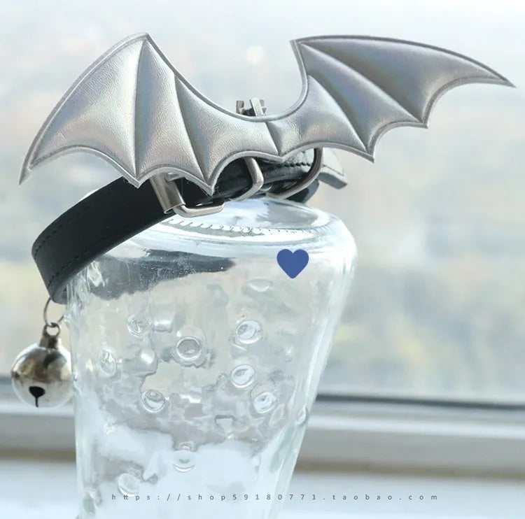 Leather dog collar with split devil wings design and bell attachment in patent leather satin material
