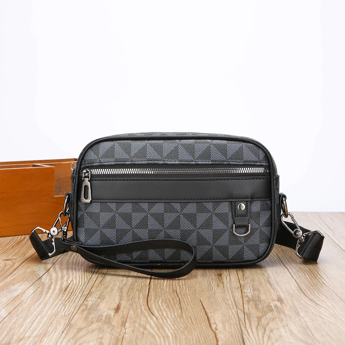 Men's black horizontal messenger bag with geometric pattern and shoulder strap