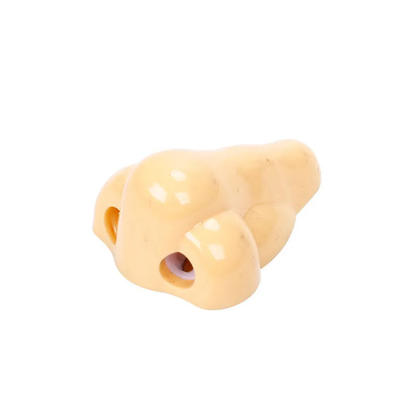 Flesh colour plastic geometry-shaped pencil sharpener with large sharpening holes.