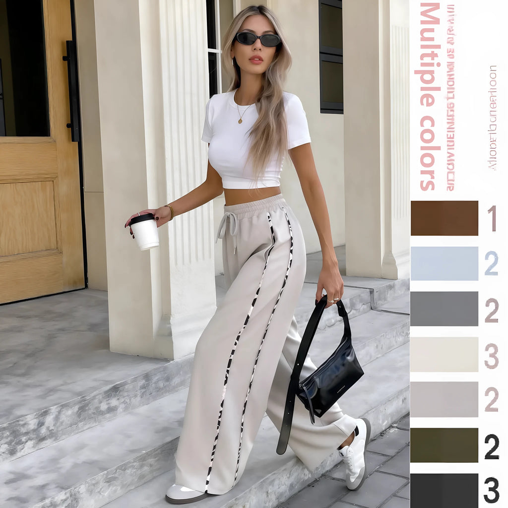 Person wearing beige loose-fit straight-leg sports trousers with a lace-up drawstring high waist.