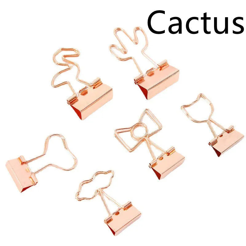 Gold metal paper clip with decorative shape options including bow, cactus, cat, flamingo, love, and clouds.