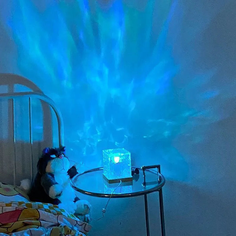 LED water ripple projection crystal table lamp with remote control on wooden surface
