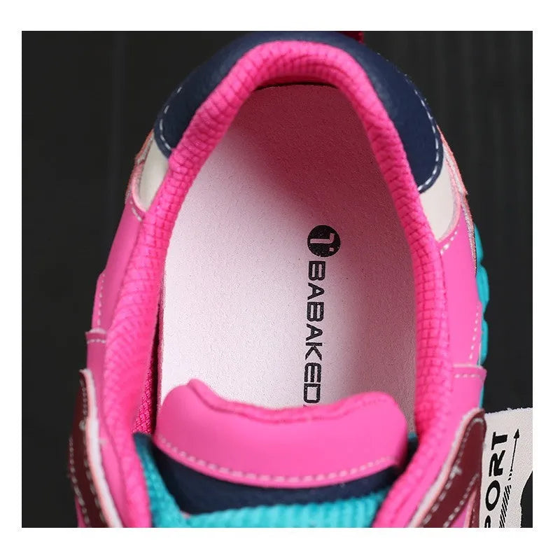 A pair of thick-soled leather casual sports shoes in a black and white colourway with a lace-up front.
