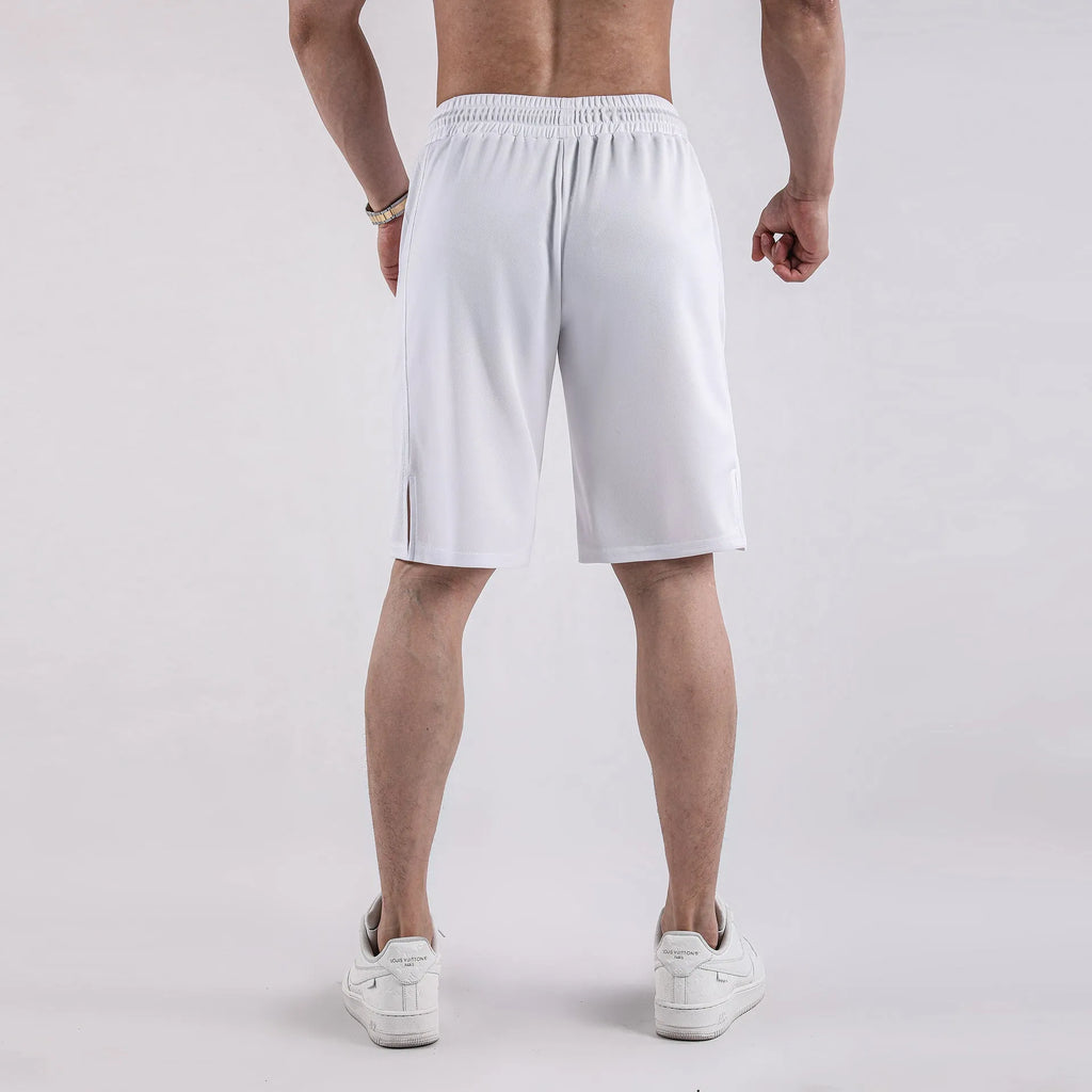 Man wearing black loose-fit quick-dry mesh Capri shorts for summer fitness.