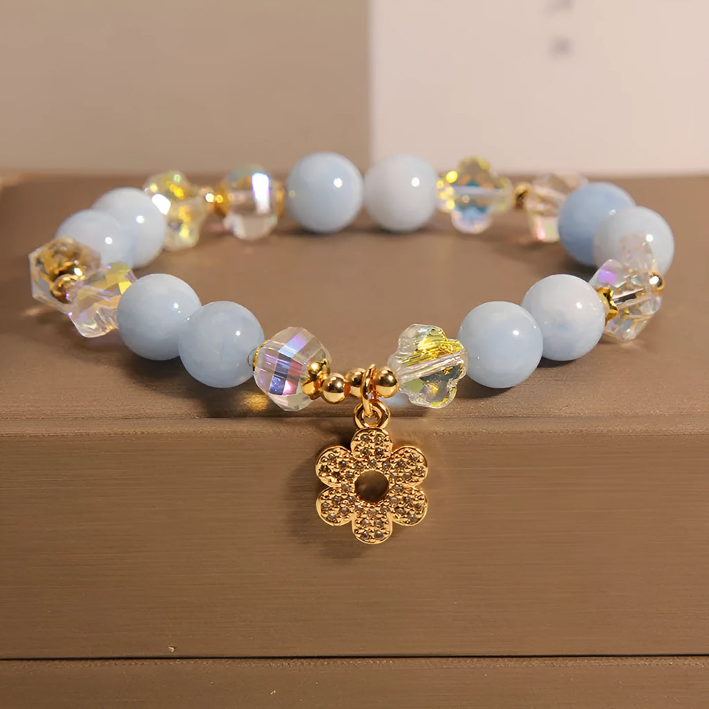 Aquamarine crystal bracelet with a four-leaf clover charm and pearl details for women.