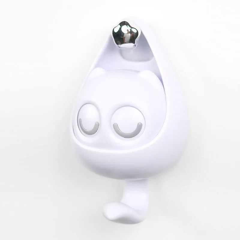 Cream white cat-shaped adhesive wall hook with winking eyes, 2.5kg capacity, 105x61x45mm