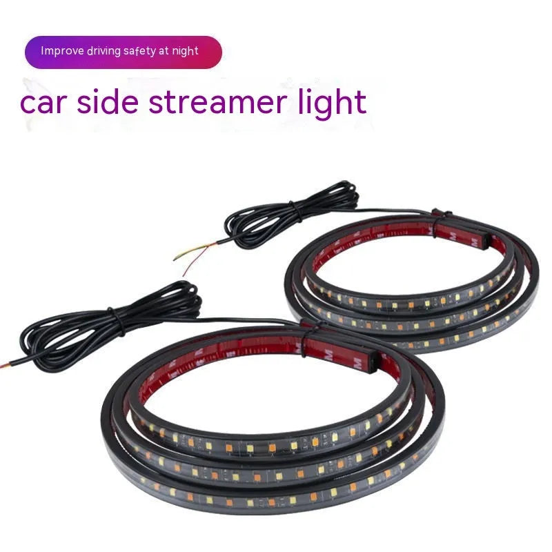 Pair of yellow pedal streamer side light lamps in flexible PVC casing on a dark background