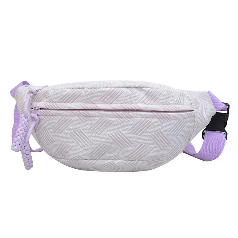 Nylon dumpling-shaped crossbody bag with single strap, zip hidden pocket, and inner patch pocket in pink, green, yellow, or purple.