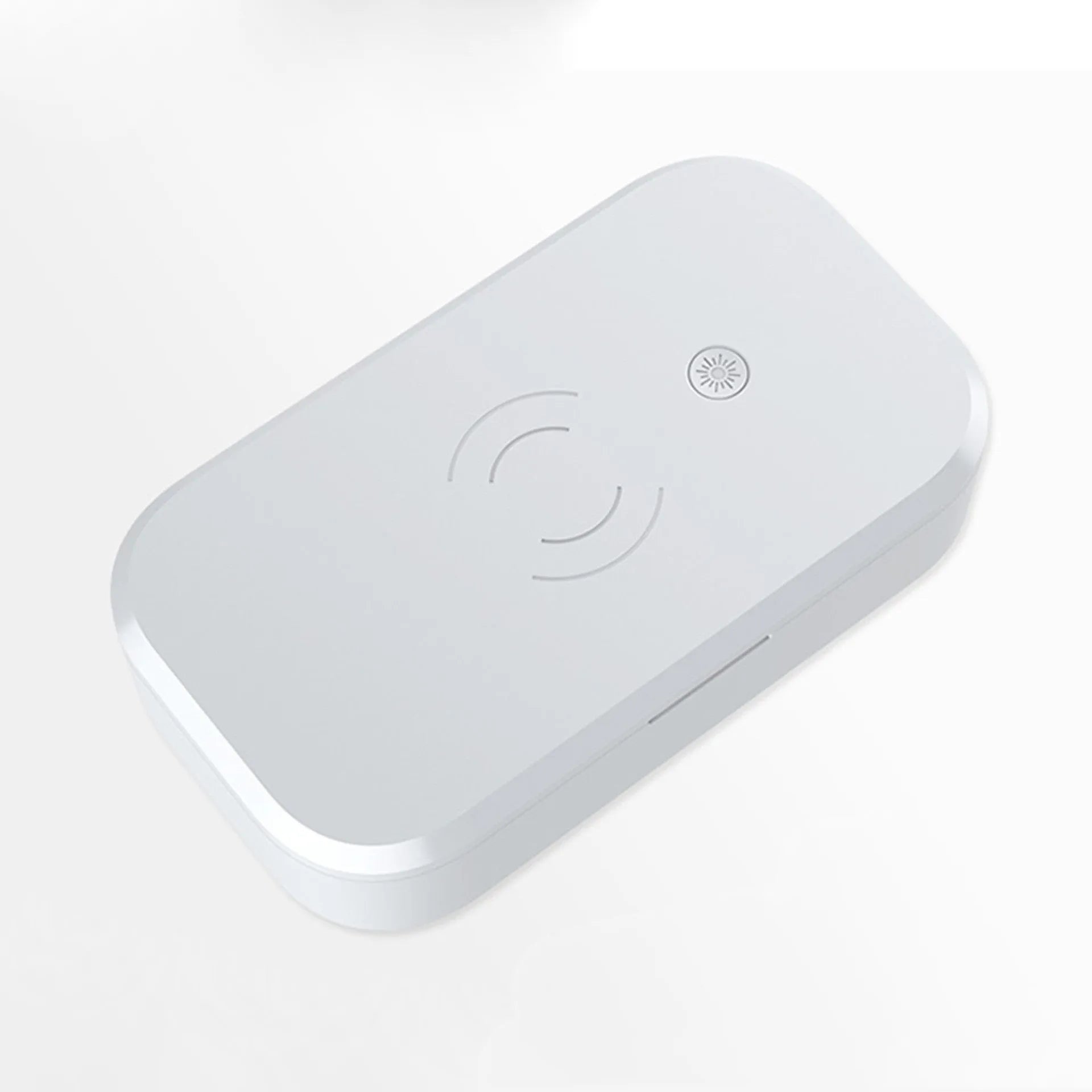 White ultraviolet disinfection box with wireless charging pad for mobile phones and beauty tools.