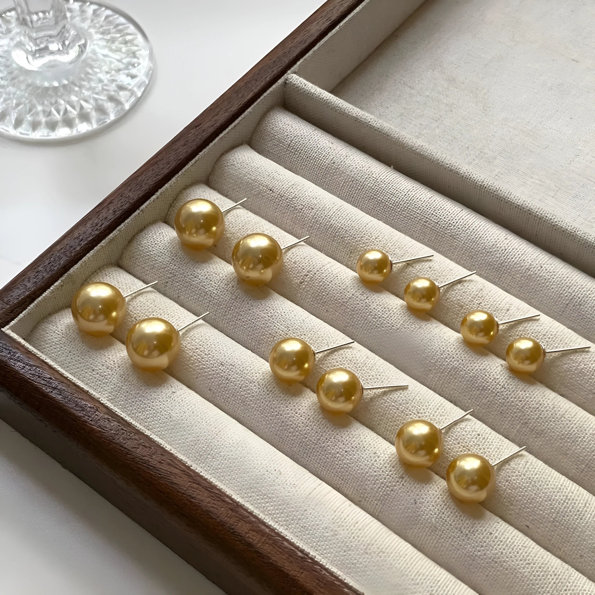 Large geometric pearl stud earrings for women with an eight-point star detail on a silver setting.