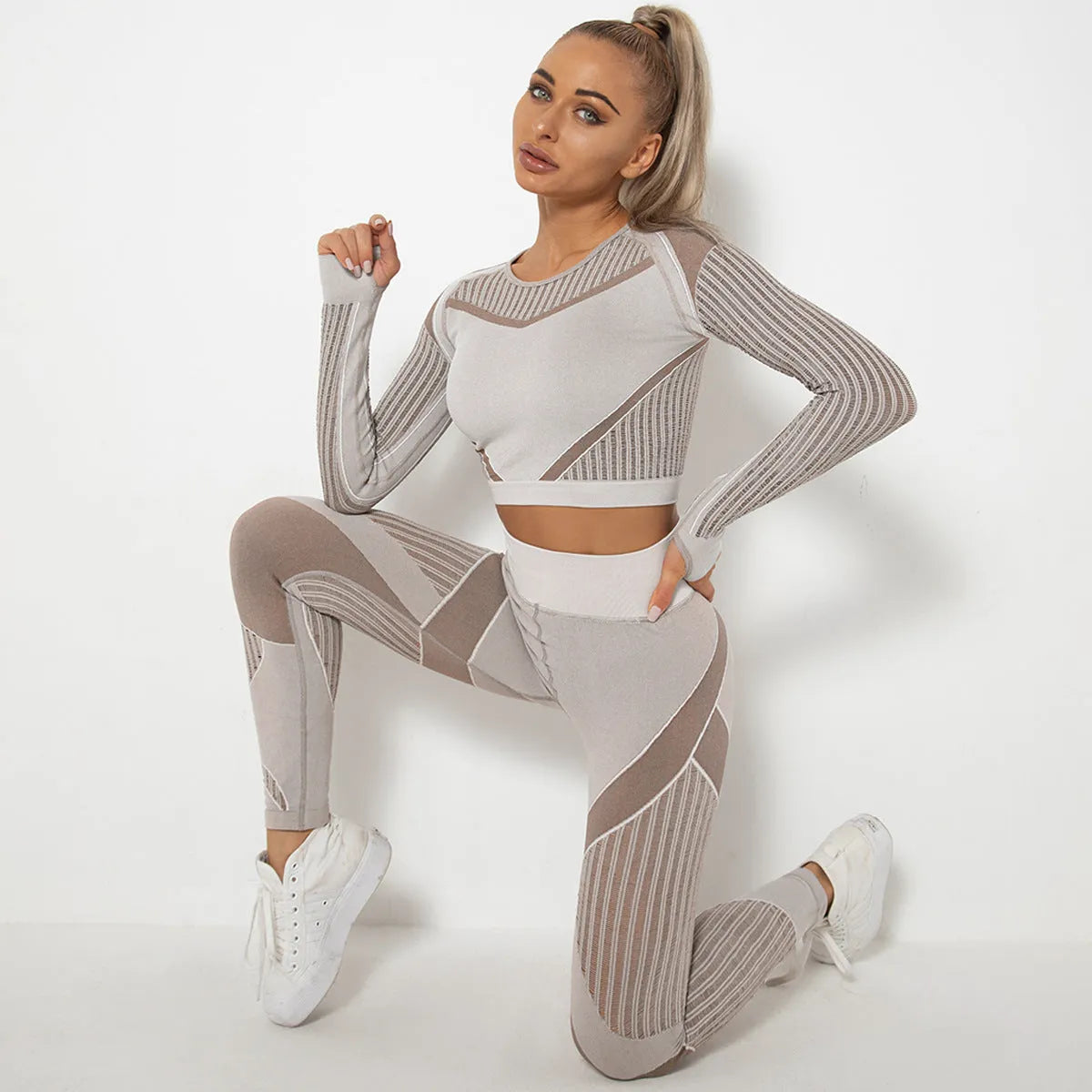 Women's long-sleeved seamless yoga wearsuit in a dark colour, shown in a yoga pose.