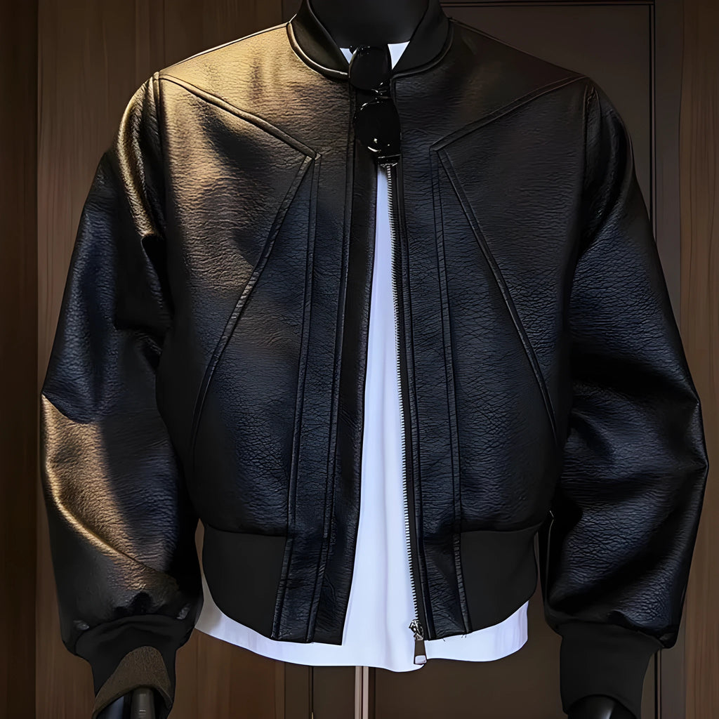Man wearing a long black PU leather jacket with a tight fit and light business style.