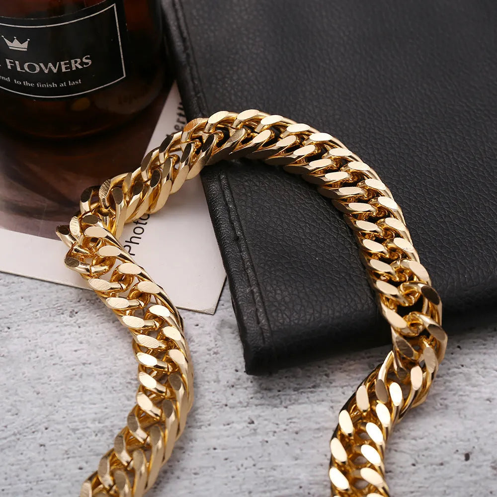Gold women's thick link chain necklace with a 6cm drop pendant on a model.