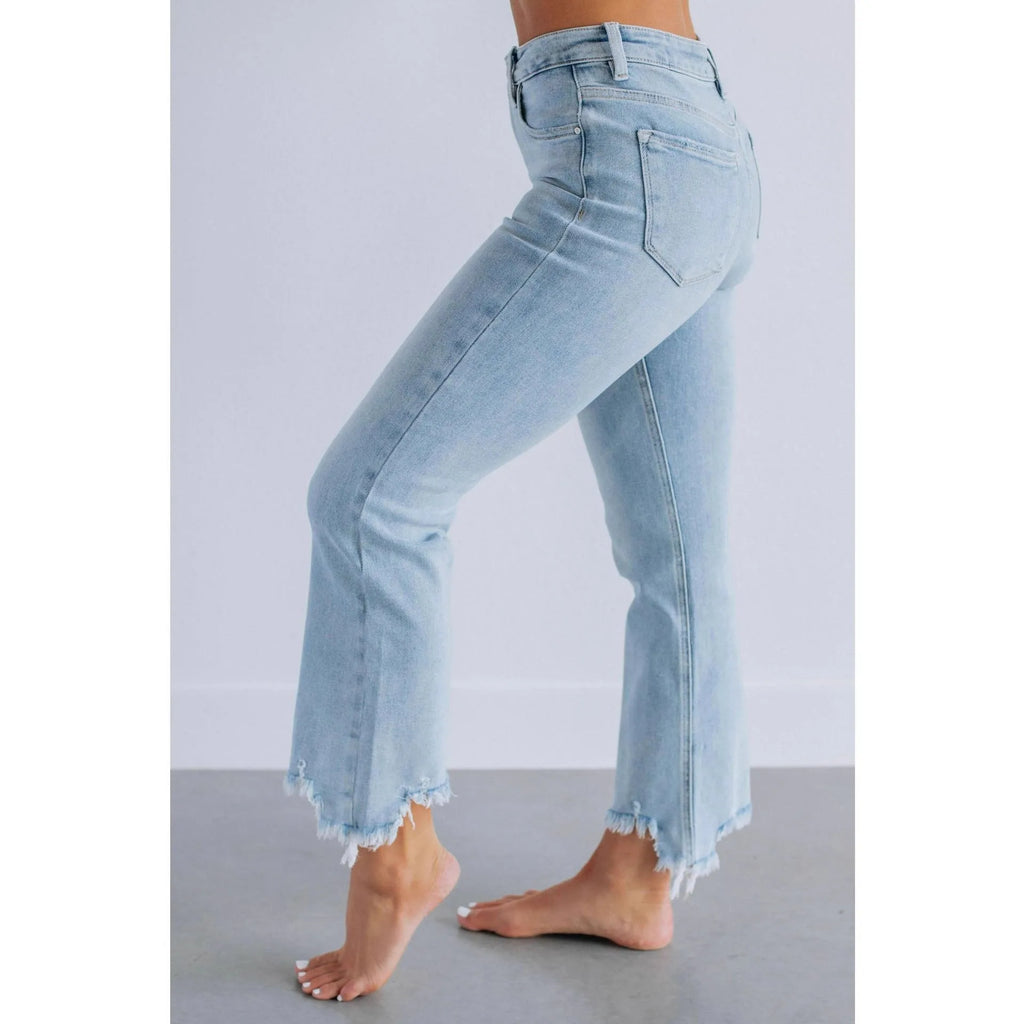 A pair of women's solid colour denim trousers with a manual wear finish, shown in dark blue.