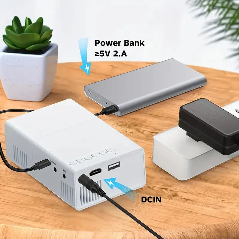 White and black portable M100 LED mini projector showing remote control and cables for 100-inch home projection.