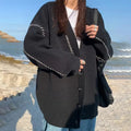 Women's loose fit knitted cardigan coat in black or white, long sleeve design