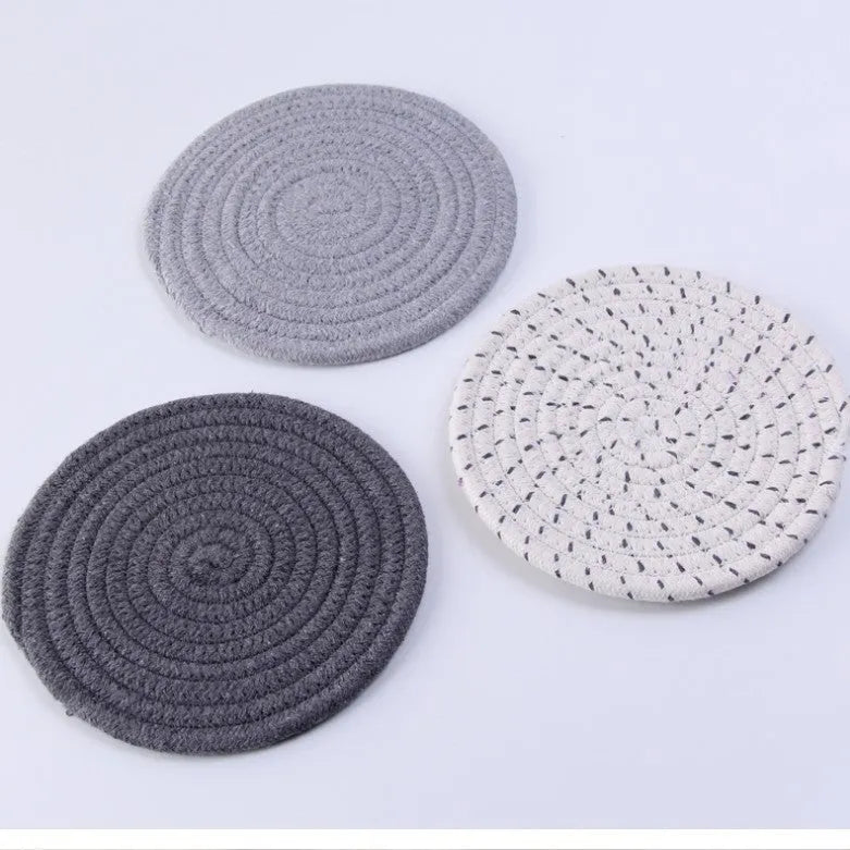 Three round cotton cord coasters in 18cm diameter showing grey, pink, purple and blue colour options