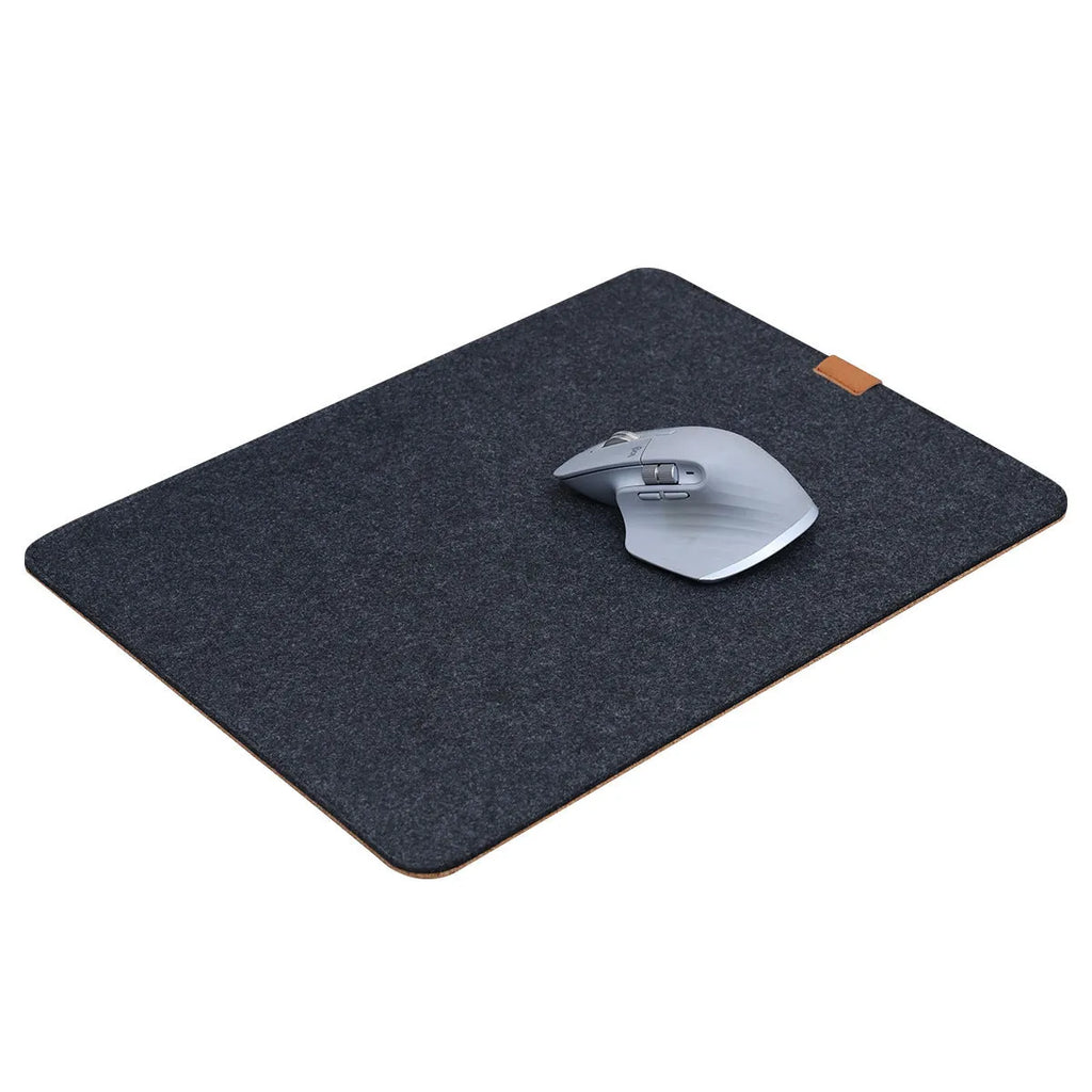 Oversized felt cork desk mat in black and grey pattern on a wooden desk